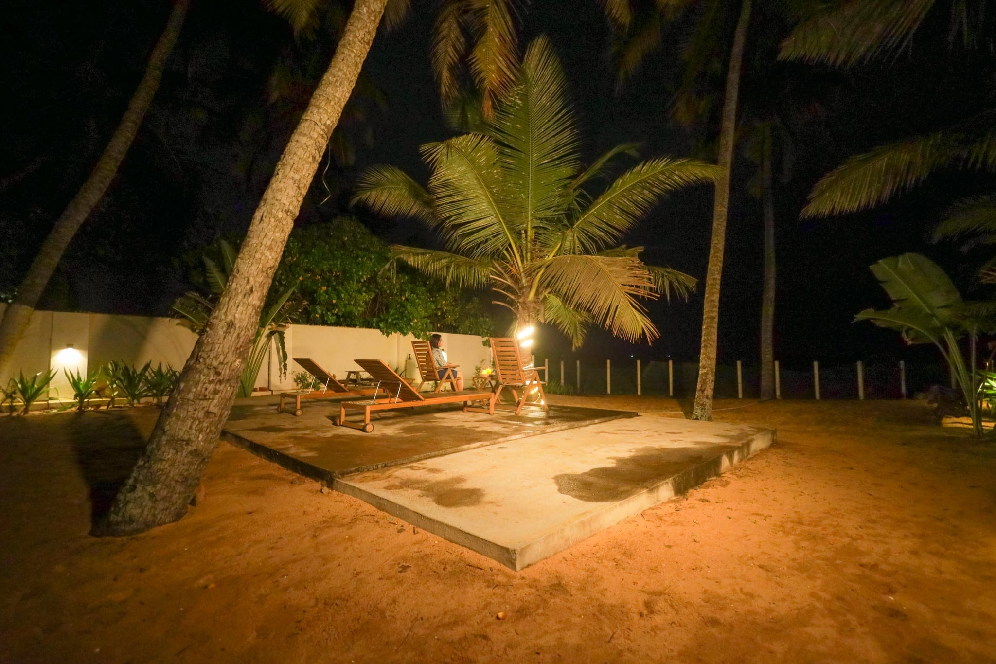 Garden lanterns among the palms at night at Heyday by the Sea, Veli, Thiruvananthapuram, Kerala