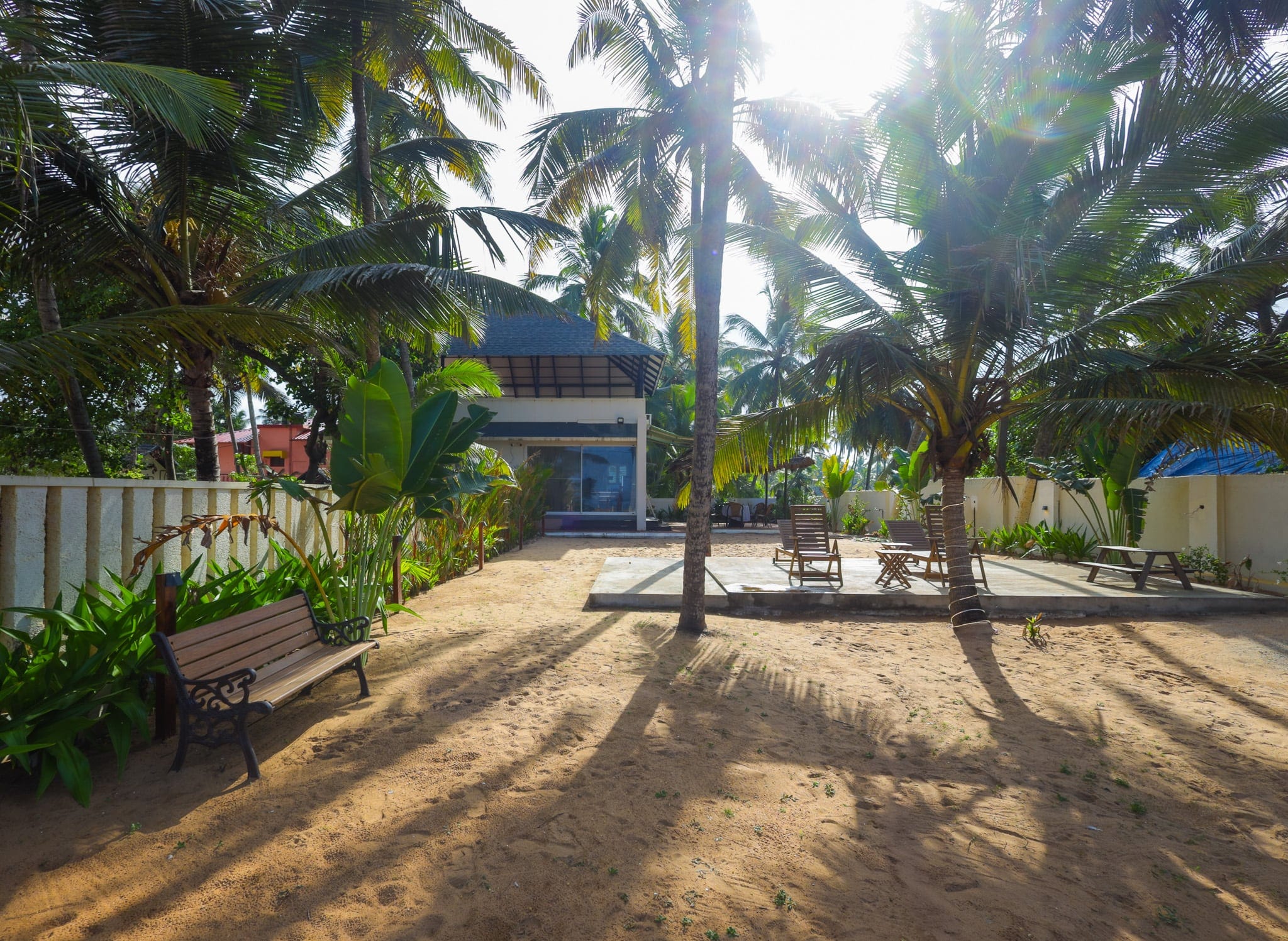 Palm-shaded lawn near the beach at Heyday by the Sea, Veli, Thiruvananthapuram, Kerala