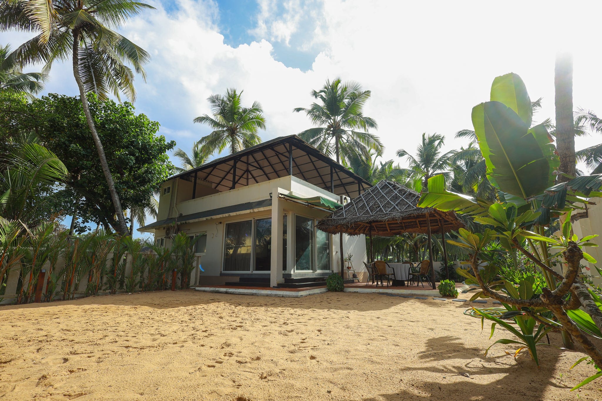 Shaded garden seating among the palms at Heyday by the Sea, Veli, Thiruvananthapuram, Kerala