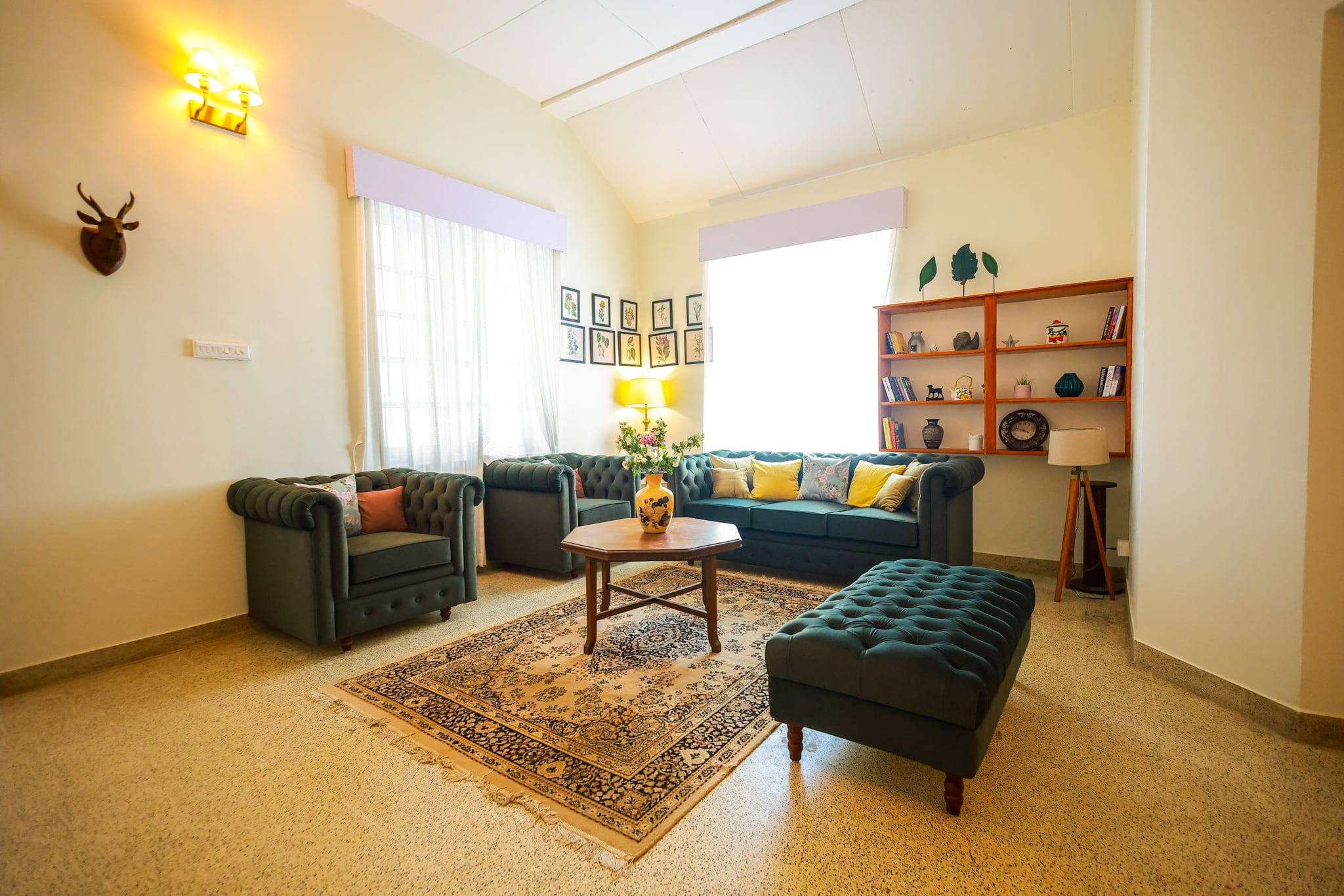 Library lounge with bookshelves and chesterfields at Heyday Planter's Portico, near Thenmala, Kollam, Kerala