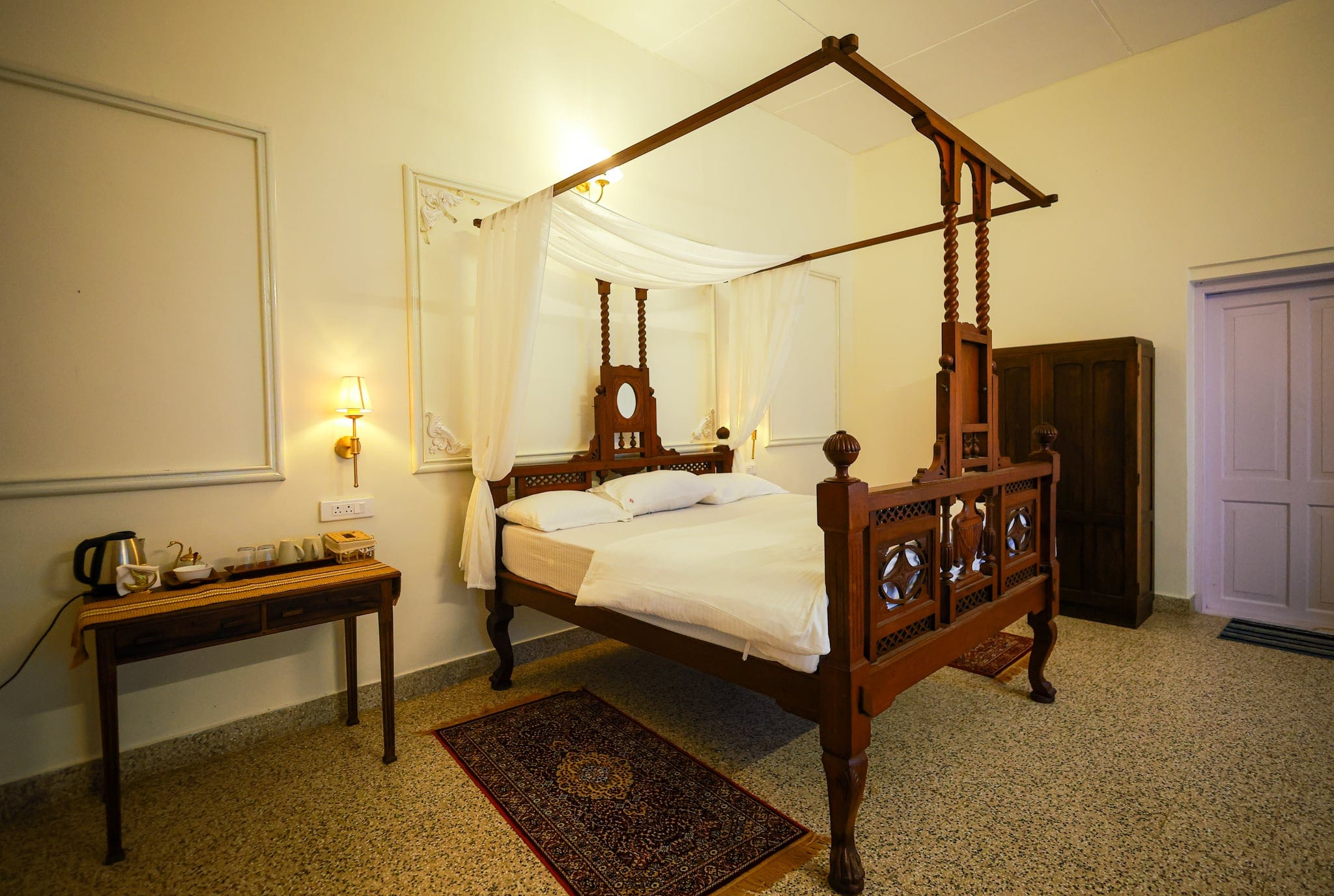 Heritage bedroom with a carved four-poster bed at Heyday Planter's Portico, near Thenmala, Kollam, Kerala