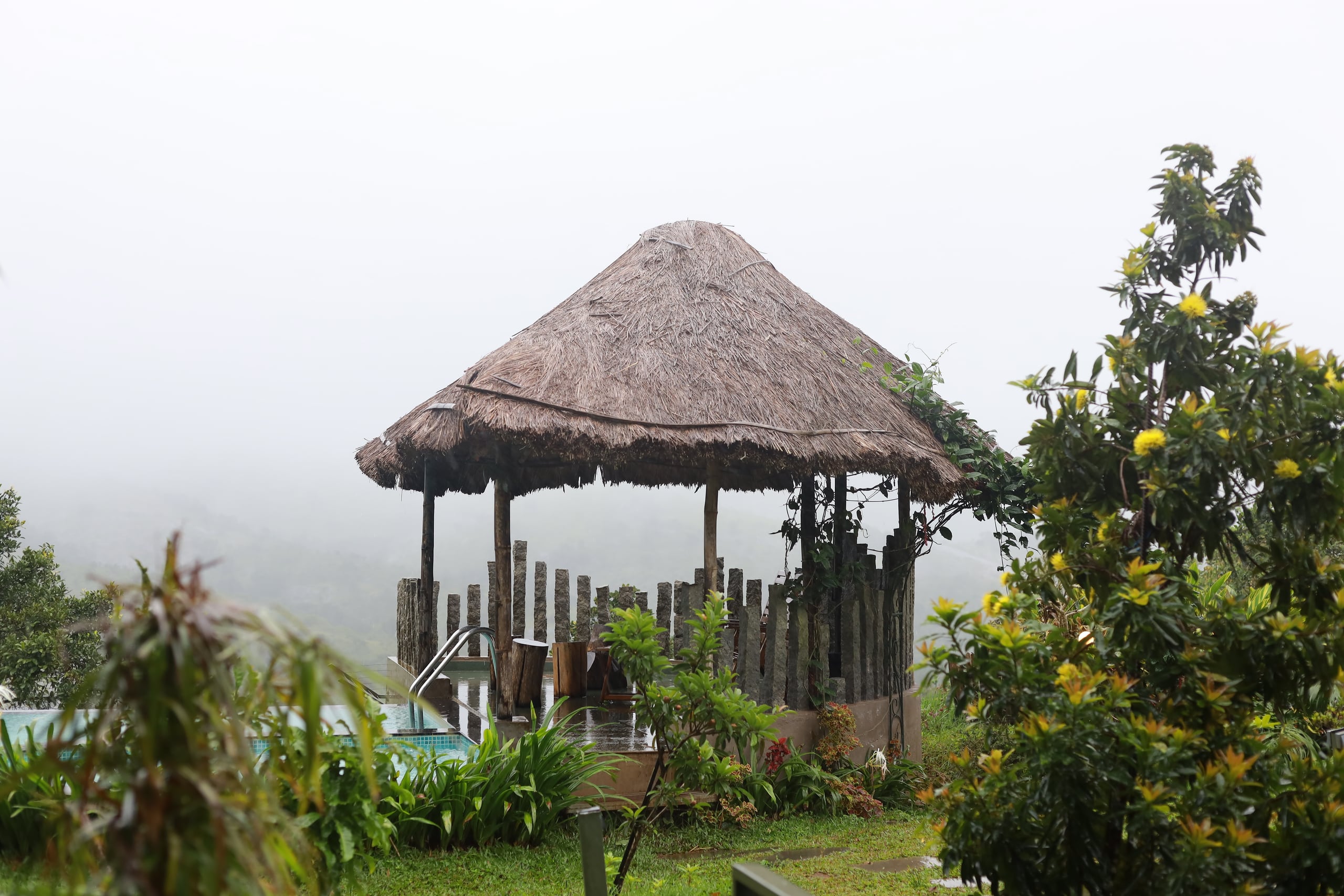 Thatched garden gazebo in the mist at Heyday Vagamon, Vagamon, Idukki, Kerala